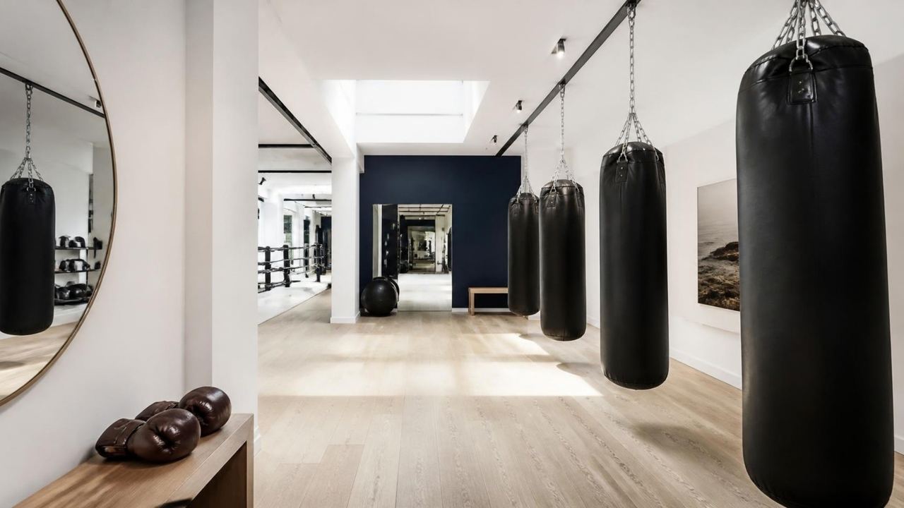Bright boxing studio with a row of heavy bags